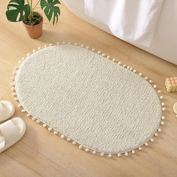 YIRDDEO Oval Rug for Bathroom, Cute Boho Bath Mat with Pom, Cream White | Soft Plush, Absorbent, Quick Dry, Machine Washable, Non Slip Bath Mat for Bathroom Shower Floor Home Decor